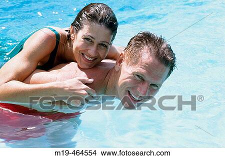 playful couple in a swiming pool View Large Photo Image Picture - playful couple in a swiming pool. Fotosearch