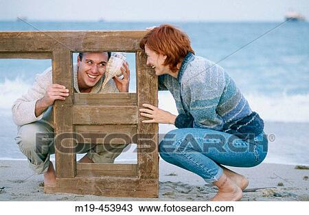playful couple on the beach View Large Photo Image Stock Image - playful couple on the beach. Fotosearch