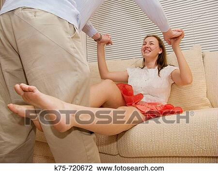 Playful couple on the couch View Large Photo Image Stock Image - Playful couple on the couch. Fotosearch
