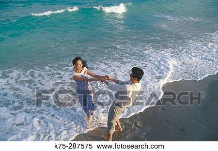playful couple on the seashore View Large Photo Image Stock Photography - playful couple on the seashore. Fotosearch