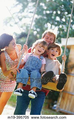 Stock Photography - playful family-kids on a swing. Fotosearch