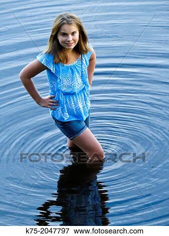playful girl standing in lake water View Large Photo Image Stock Photo - playful girl standing in lake water. Fotosearch