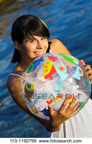 Stock Photo - Playful teenager girl with a ball. Fotosearch