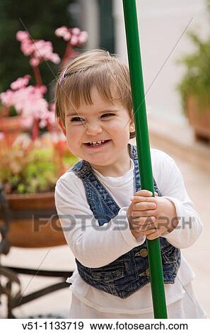 Playful young smiling girl in patio View Large Photo Image Stock Photo - Playful young smiling girl in patio. Fotosearch