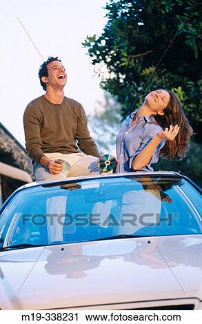 Stock Image - playing CDs in a car and dancing. Fotosearch