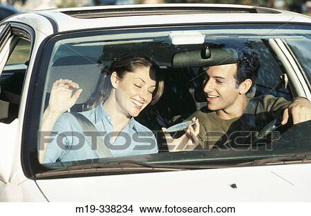 Picture - playing CDs in a car. Fotosearch