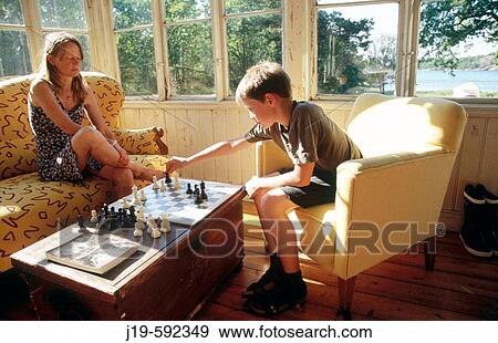 Stock Photo - Playing chess, children and adults on the summer balcony.. Fotosearch