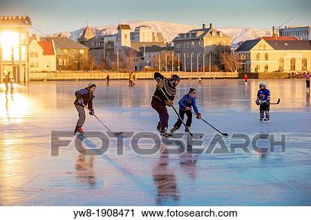 Stock Image - Playing ice hockey on the pond in Reykjavik, Iceland Tjornin is the Icelandic name for The Pond. Fotosearch