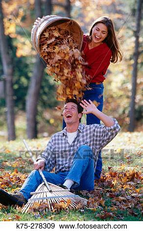 Playing in a pile of leaves View Large Photo Image Stock Photo - Playing in a pile of leaves. Fotosearch