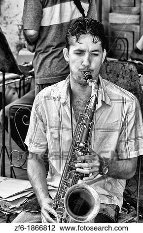 Playing music on the streets of Cienfurgos Cuba View Large Photo Image Stock Image - Playing music on the streets of Cienfurgos Cuba. Fotosearch