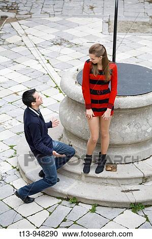 Stock Image - Playing proposition young couple. Fotosearch