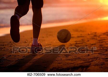 Playing the ball on the beach at sunset View Large Photo Image Stock Photo - Playing the ball on the beach at sunset. Fotosearch