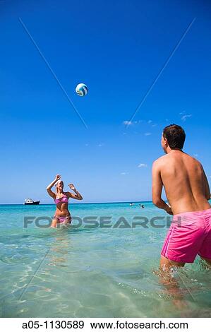Playing volleyball. Binigaus beach. Minorca. Balearic Islands. Spain. View Large Photo Image Stock Photo - Playing volleyball. Binigaus beach. Minorca. Balearic Islands. Spain.. Fotosearch
