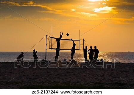 Playing Volleyball on Karon Beach at Sunset, Phuket, Thailand. View Large Photo Image Picture - Playing Volleyball on Karon Beach at Sunset, Phuket, Thailand.. Fotosearch