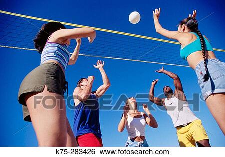 Stock Photograph - Playing volleyball. Fotosearch
