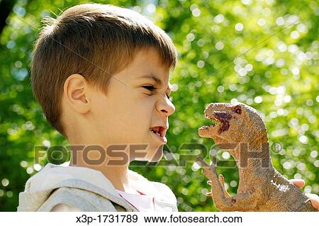 Playing with a Tirannosarusu rex View Large Photo Image Stock Photo - Playing with a Tirannosarusu rex. Fotosearch