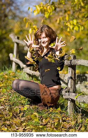 Playing with Autumn fallen leaves View Large Photo Image Stock Photography - Playing with Autumn fallen leaves. Fotosearch