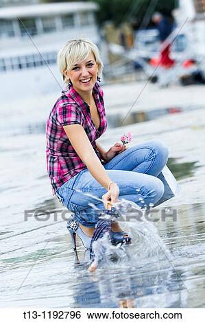 Playing with umbrella and water joyful young woman View Large Photo Image Stock Photograph - Playing with umbrella and water joyful young woman. Fotosearch