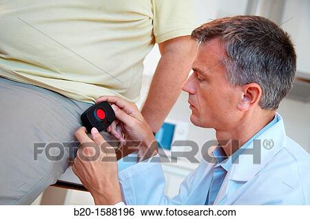 Stock Photograph - PLS researchers taught an older mobile tele care device for automatic detection of falls that sits at the waist. Fotosearch