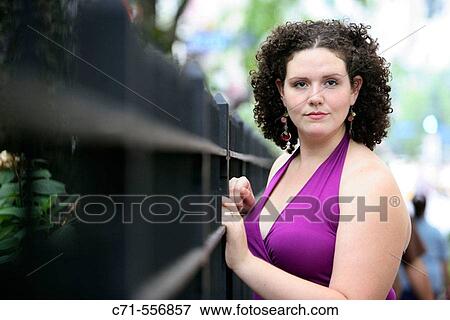 Plus size caucasian woman leaning on fence and looking off View Large Photo Image Stock Photo - Plus size caucasian woman leaning on fence and looking off. Fotosearch