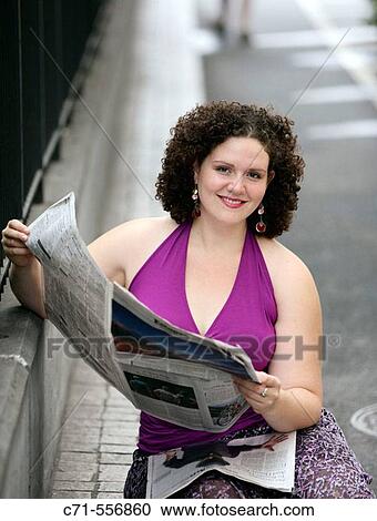 Plus size caucasian woman looking into camera reading newspaper View Large Photo Image Stock Image - Plus size caucasian woman looking into camera reading newspaper. Fotosearch