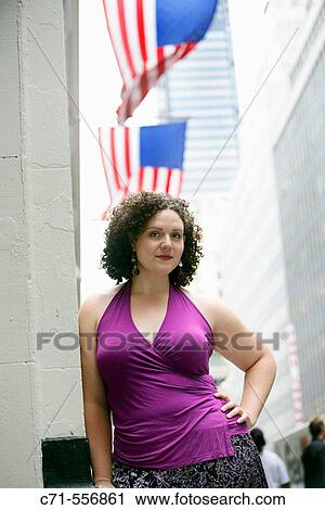 Plus size caucasian woman looking into camera with american flags in background View Large Photo Image Stock Image - Plus size caucasian woman looking into camera with american flags in background. Fotosearch