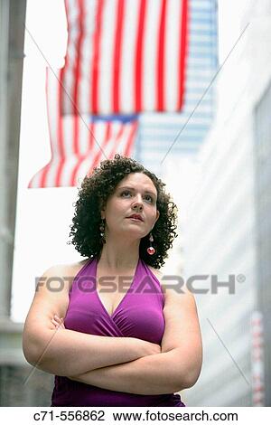 Plus size caucasian woman looking into future on street with american flags in background View Large Photo Image Stock Image - Plus size caucasian woman looking into future on street with american flags in background. Fotosearch