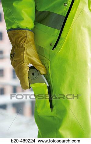 Pocket for mobile phone. Technician with safety equipment. Housing construction, apartments. San Sebastian, Gipuzkoa, Euskadi. Spain. View Large Photo Image Picture - Pocket for mobile phone. Technician with safety equipment. Housing construction, apartments. San Sebastian, Gipuzkoa, Euskadi. Spain.. Fotosearch