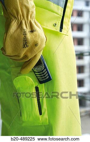 Pocket for mobile phone. Technician with safety equipment. Housing construction, apartments. San Sebastian, Gipuzkoa, Euskadi. Spain. View Large Photo Image Stock Photography - Pocket for mobile phone. Technician with safety equipment. Housing construction, apartments. San Sebastian, Gipuzkoa, Euskadi. Spain.. Fotosearch