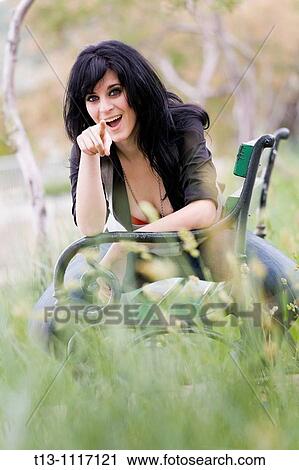 Pointing with a finger in the park attractive young woman View Large Photo Image Stock Image - Pointing with a finger in the park attractive young woman. Fotosearch