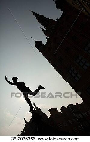 Stock Photograph - Poland, Gdansk, Old Town. The silhouette of Hermes and the Town Hall.. Fotosearch