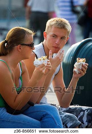 Poland Krakow, couple eating fast food View Large Photo Image Stock Image - Poland Krakow, couple eating fast food. Fotosearch