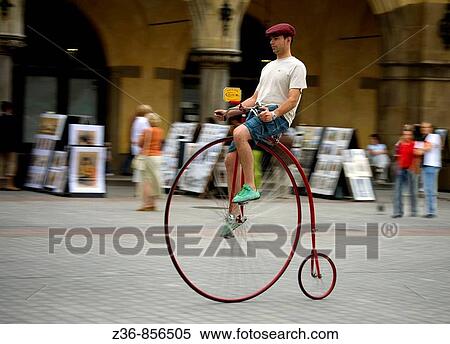 Poland, Krakow, Main Market Square, man rides an old bicycle View Large Photo Image Stock Photography - Poland, Krakow, Main Market Square, man rides an old bicycle. Fotosearch