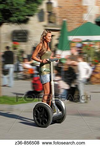 Poland Krakow, Main Market Square, woman rides sagway View Large Photo Image Stock Photo - Poland Krakow, Main Market Square, woman rides sagway. Fotosearch
