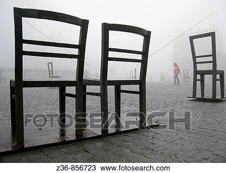 Stock Image - Poland, Krakow, Podgorze district, Memorial to the heroes of the Krakow ghetto, metal chairs. Fotosearch