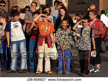 Stock Photo - Poland, Krakow, spectators at Main Market Square. Fotosearch