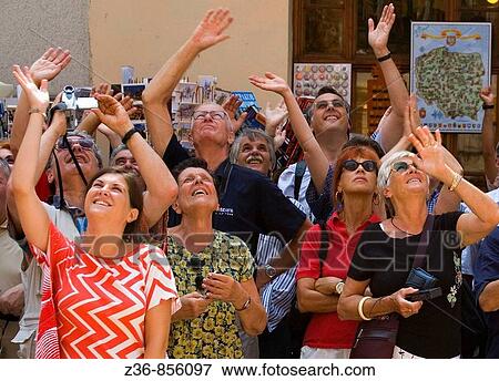 Poland Krakow Tourists watches as trumpeter plays anthem from St Mary's Church Tower View Large Photo Image Stock Photo - Poland Krakow Tourists watches as trumpeter plays anthem from St Mary's Church Tower. Fotosearch