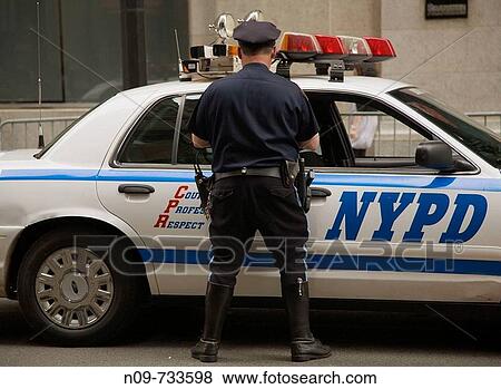 Policeman and patrol car, New York City, USA View Large Photo Image Stock Photo - Policeman and patrol car, New York City, USA. Fotosearch