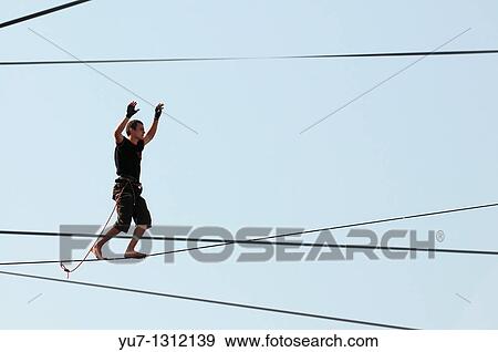 Stock Photo - Polish slackliner Damian Czermak during show in Warsaw, Poland. Fotosearch