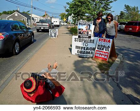 Political protest on sidewalk in Vineyard Haven, Martha's Vineyard, Massachusetts. A proessional photographer is documenting the event for a local paper. View Large Photo Image Stock Image - Political protest on sidewalk in Vineyard Haven, Martha's Vineyard, Massachusetts. A proessional photographer is documenting the event for a local paper.. Fotosearch