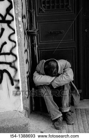 Stock Image - Poor beggar sleeping on the Entrace of a Door in Istanbul. Fotosearch