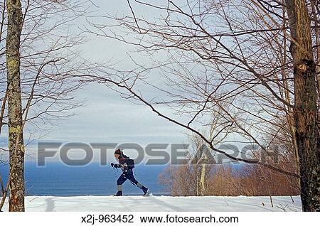 Stock Image - Porcupine Mountains State Park, Michigan - Fred Fechheimer, 65, skis along a ridge above Lake Superior while on a winter camping trip in the Porcupine Mountains. Fotosearch