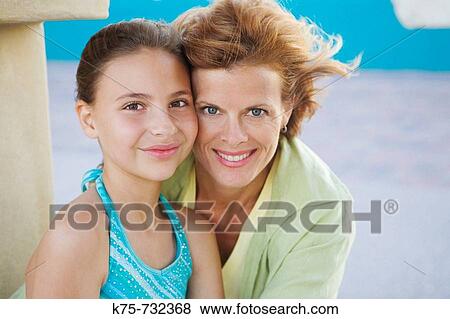 Portait of mom and daughter cheek to cheek View Large Photo Image Stock Photo - Portait of mom and daughter cheek to cheek. Fotosearch