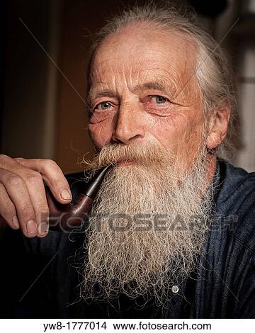 Portait of senior man with beard smoking a pipe View Large Photo Image Picture - Portait of senior man with beard smoking a pipe. Fotosearch