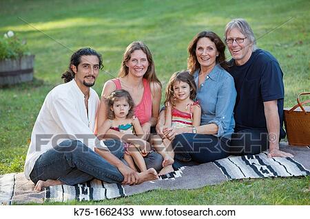 Stock Image - Portait of three generations on blanket outdoors. Fotosearch