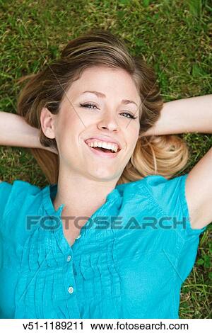 Portarit of a content blonde woman in the park View Large Photo Image Stock Image - Portarit of a content blonde woman in the park. Fotosearch