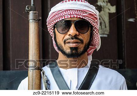 Stock Photo - Portrait bedouin in traditional clothes in Old Al Ain Palace. Al Ain, United Arab Emirates.. Fotosearch
