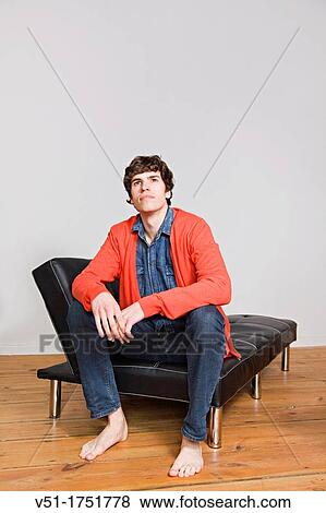 Portrait if a young man at the sofa View Large Photo Image Stock Photo - Portrait if a young man at the sofa. Fotosearch