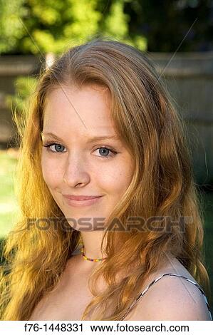 Stock Image - Portrait of 17 year old teenage girl with long strawberry blonde hair. Fotosearch