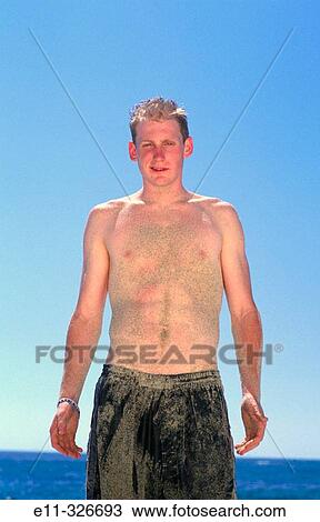 Portrait of 21 year old man wearing bathing suit, covered with sand View Large Photo Image Stock Image - Portrait of 21 year old man wearing bathing suit, covered with sand. Fotosearch